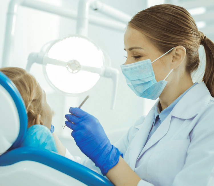 Dental hygienist performing patient dental cleaning
