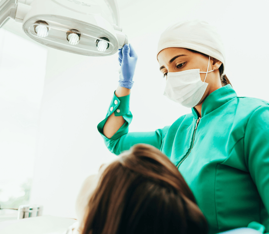 Dentist preparing to exam a patient