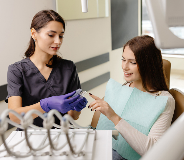 Dentist showing Invisalign to patient
