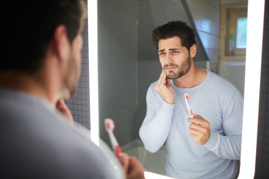 Sad man getting bad tooth
