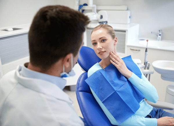 Teenager at dentist wisdom teeth pain