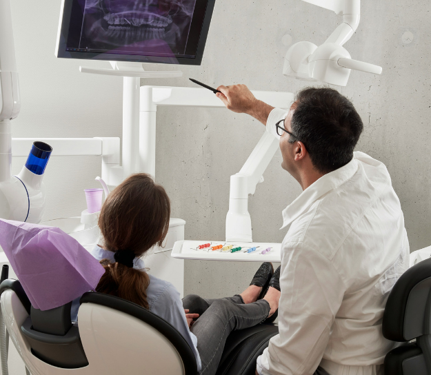 Dentist reviewing x-ray with patient