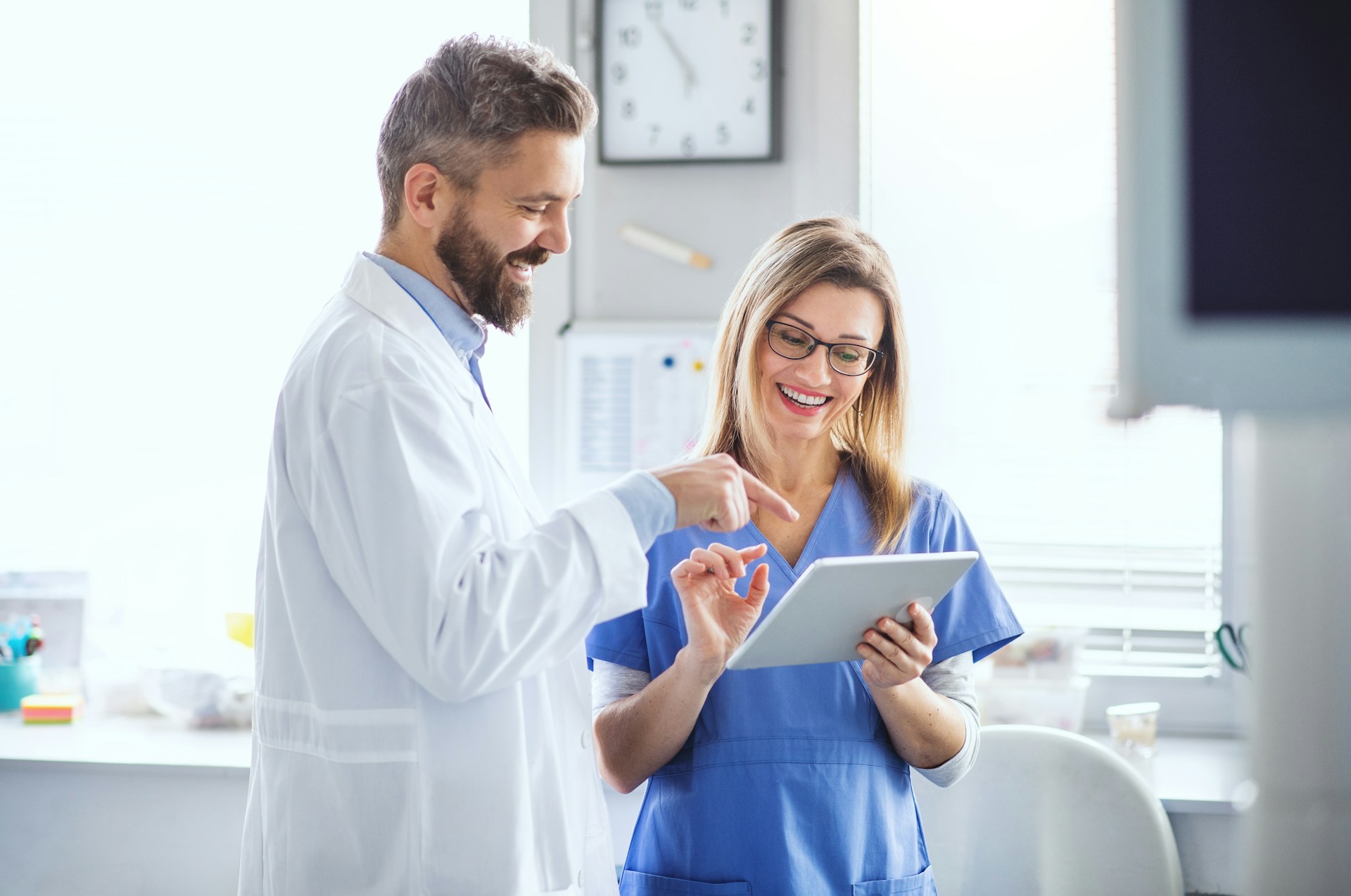 dentist reviewing clients file with assistant