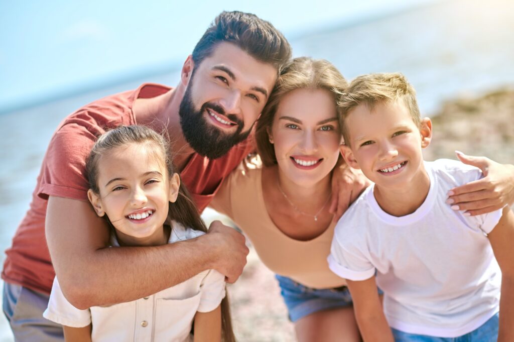 A picture of happy smiling family having fun on a beach