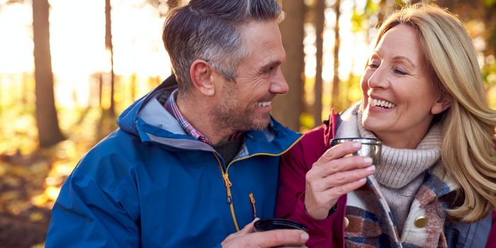 Mature Retired Couple Stop For Rest And Hot Drink On Walk Through Fall Or Winter Countryside