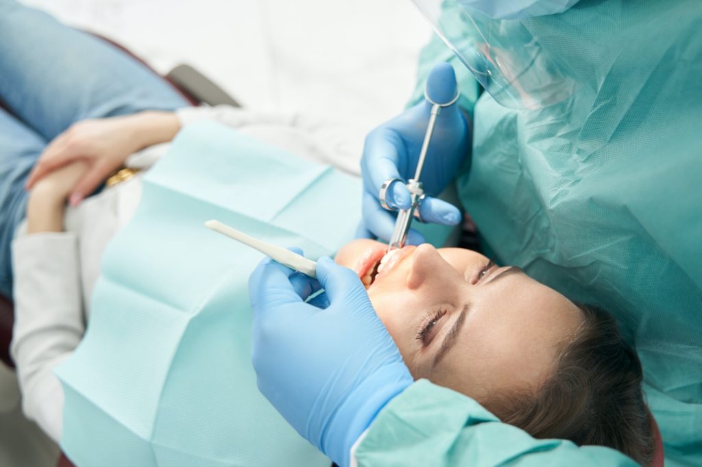 Female patient receiving dental treatment with sedation options