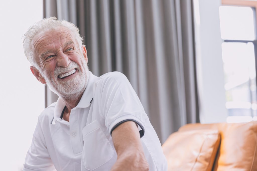 happy elderly man healthy senior confident smile with beautiful white teeth from denture prosthetics