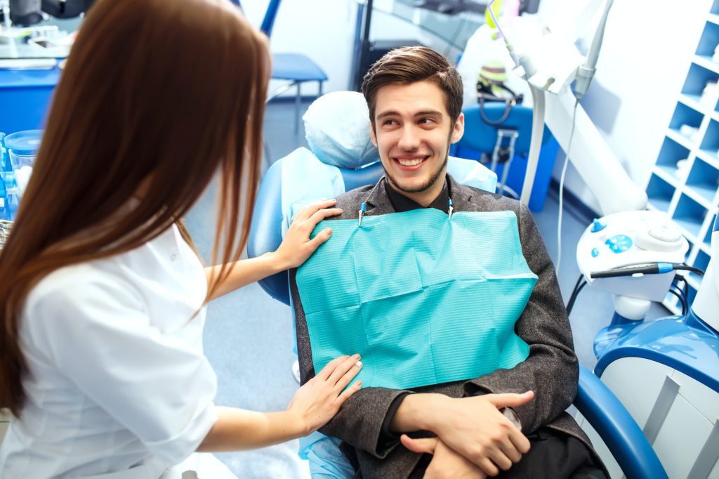 Professional woman dentist doctor working . Man dental clinic. man at dentist taking care of teeth.