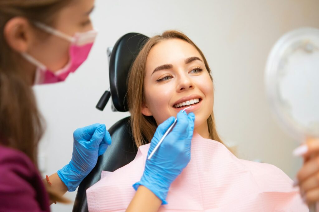 Woman patient sitting in armchair during dental treatment